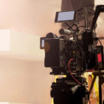 A film operator handling a camera on a set.